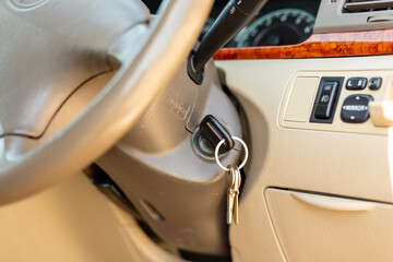 car key inserted into the lock of ignition. Closeup with selective focus.