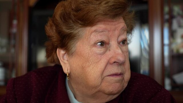 Portrait of talkative elderly woman grimacing with happiness and concern