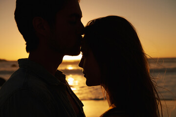 Couple, beach and sunset or silhouette love on vacation for coast holiday, connection or bonding. Man, woman and hug embrace at sea ocean for summer travel or evening journey, explore or together