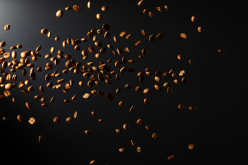 Coffee beans in motion on a black background.