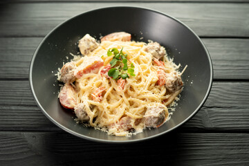 Italian pasta with meatballs on a plate in a restaurant. Food concept.