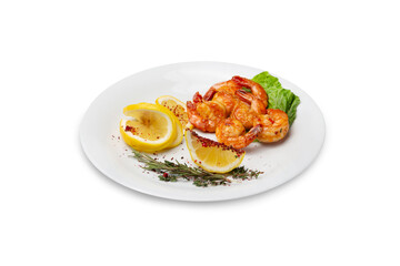 Shrimp fried in sauce with lemon on a plate, isolated