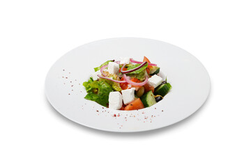 Greek salad from vegetables and cheese on a plate, isolated