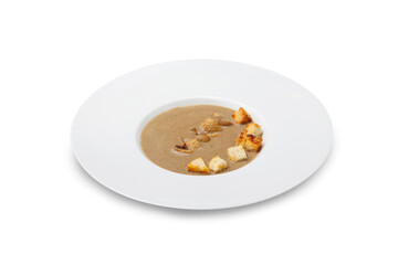 Mushroom soup with croutons in a plate, isolated