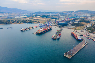 Naklejka premium Aerial view of Industrial port with container terminal with loading and unloading cargo ships
