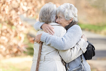 Nature, love and senior friends hugging for support, bonding or care in outdoor park or garden....