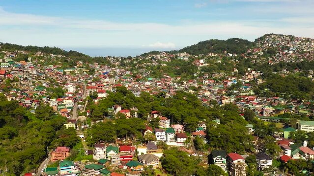 Aerial view of hillside houses in the city of Baguio in a mountainous province. Philippines, Luzon.