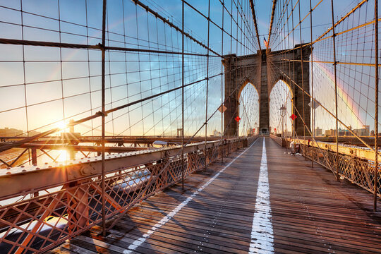 Rainbow over Brooklyn bridge in New York City at sunrise, USA