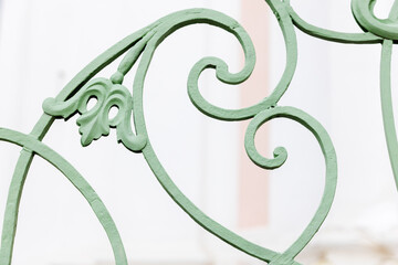Vintage green forged railings, close-up photo