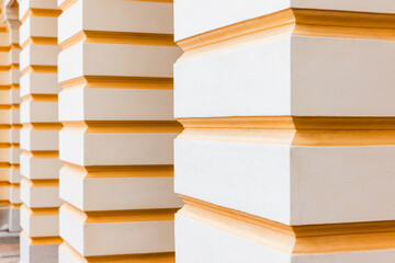 Abstract classic architecture details, white pillars with yellow stripes