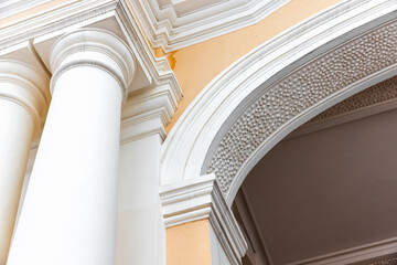 Classical portico details. White pillars and arch