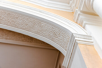 Classical portico details. White arched doorway