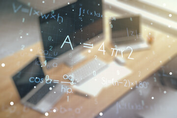 Creative scientific formula hologram and modern desk with computer on background, research concept....