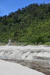 Driftwood structure by stream and mountain 