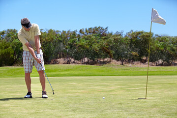 Obraz premium Sport, man and golf on grass outdoor for playing, performance and game with fitness and wellness. Athlete, mature person and golfer with club, ball and exercise on field for recreation, hobby and fun