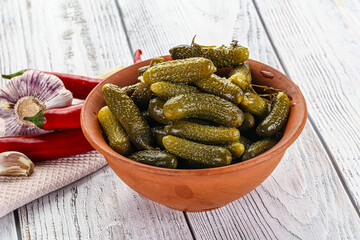 Marinated small cucumbers in the bowl