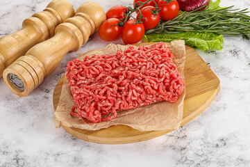 Raw minced beef meat on cutting board