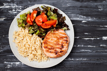 grilled meat hamburger with boiled rice and salad on white dish