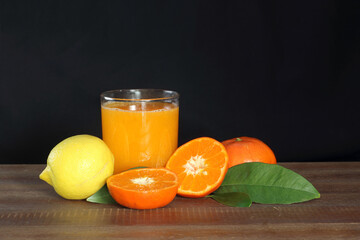 tangerine juice in a glass on dark background