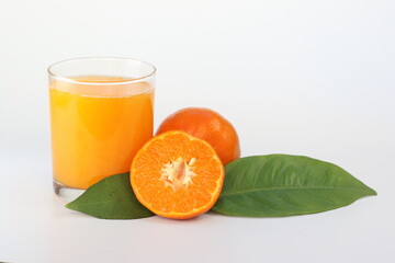 tangerine juice in a glass on white background