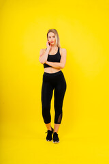 Fototapeta na wymiar Happy fit woman over studio background. Smiling female fitness workout. Healthy lifestyle concept.