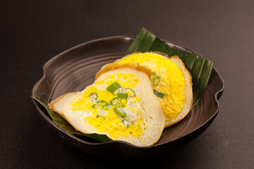 Surabi Endok or Serabi Or sorabi with Egg for Topping, Indonesian traditional food and cuisine.