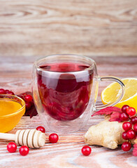Tea from viburnum berries with ginger, lemon and honey. Close-up. Selective focus.