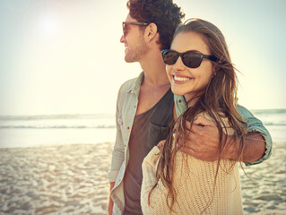 Couple, sea and sunglasses with hug, smile or care for fashion, eye protection or vacation in...