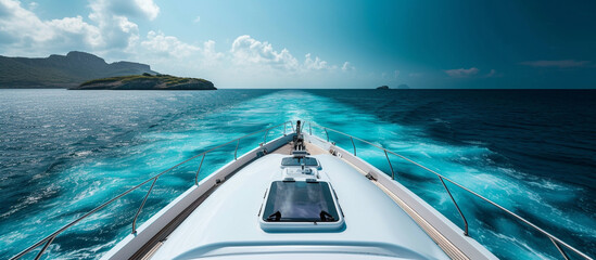 Ocean front view of tropical island from bow yacht. luxury romantic travel.