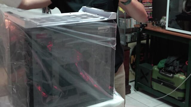 A guy unboxing a PC case.