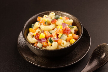 Macaroni Salad with Bell Pepper, Onion, Corn and Mayonnaise Dressing.