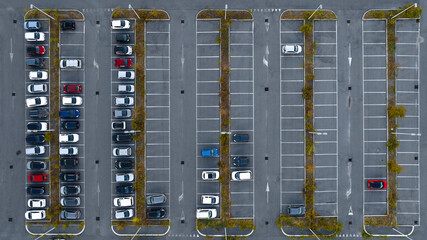 Perpendicular or zenithal aerial view on a car park outside a department store.