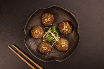 Tteokgalbi or Korean Grilled Short Rib Beef Patties, Top with Pine Nuts and  Served with Kimchi