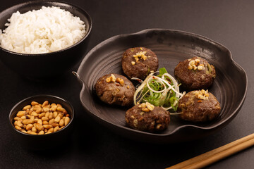Tteokgalbi or Korean Grilled Short Rib Beef Patties Topping with Pine Nuts and Served with Rice .