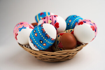 Easter basket with Easter Eggs on white background
