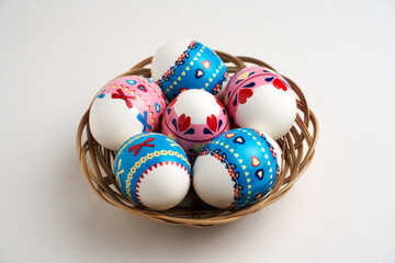 Easter basket with Easter Eggs on white background