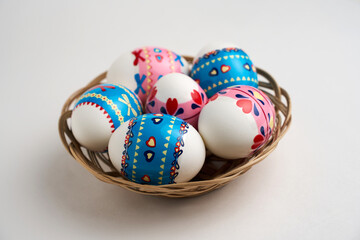 Easter basket with Easter Eggs on white background