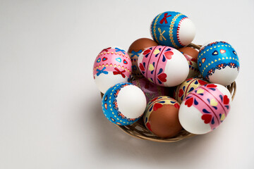 Easter basket with Easter Eggs on white background