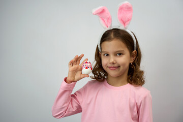 Funny happy child girl with easter eggs and bunny ears