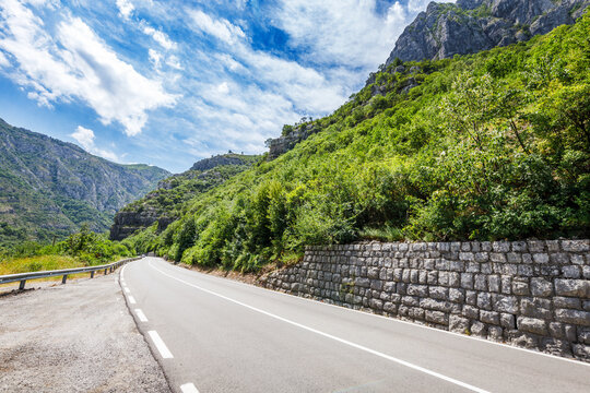 Mountain landscape of Montenegro with road and old brick wall