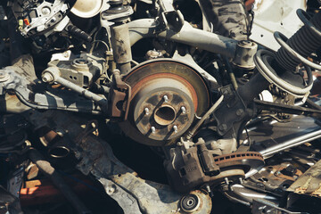 Wheel hubs laid out as scrap metal at a junkyard