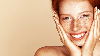 Skin care. Pigmentation. Beauty portrait of a girl with a freckles. Beautiful model with beautiful natural ginger red hair - obrazy, fototapety, plakaty