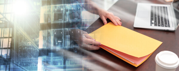 Businesswoman holding folder; multiple exposure