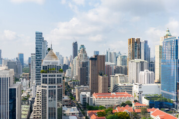 Closeup image of Bangkok cityscape. Modern cityscape surrounded with architectural building with day light and blue sky. Side view. Business background. Day light. Ornamented. - obrazy, fototapety, plakaty