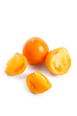 Cut and whole of yellow tomato isolated on white background.