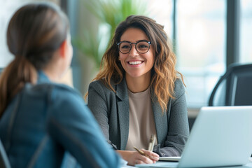 Happy businesswoman interviewing a well-prepared job candidate in a cozy office environment. The job interview process - from expectation to excitement, captured in high-definition