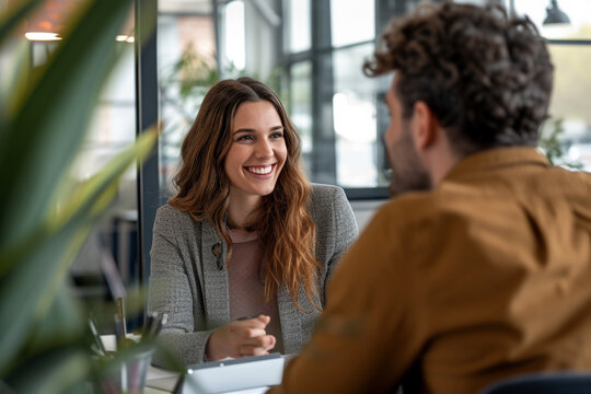 Happy businesswoman interviewing a well-prepared job candidate in a cozy office environment. The job interview process - from expectation to excitement, captured in high-definition
