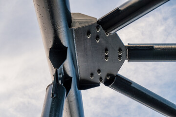 Steel construction of modern pedestrian footbridge. Detail with rivets and screws