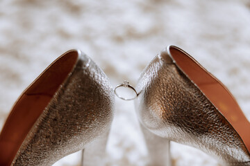 Bride's shoes. The girl wears stilettos. Elegant women's shoes. Beautiful details. The bride puts on her shoes and prepares for the wedding ceremony