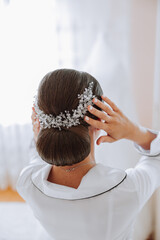 Close-up view from the back. A diadem in the bride's hair. The concept of wedding jewelry. The...